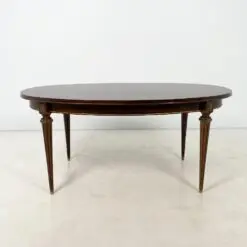 Ovalus išskleidžiamas raudonmedžio valgomojo stalas su žalvario apdailomis 106×171(+60)x77,5 cm
