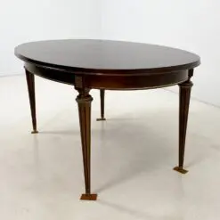 Ovalus išskleidžiamas raudonmedžio valgomojo stalas su žalvario apdailomis 106×171(+60)x77,5 cm