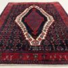 Persiškas raudonas rankų darbo kilimas su geometriniais ornamentais iš vilnos