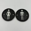 Apvalūs tualeto durų ženklai iš ketaus su vyrišku ir moterišku siluetais