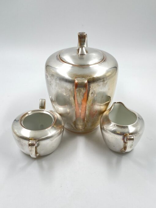 Metalinių su keramikiniu vidumi arbatinuko (1600 ml) 15x25x21 cm, ąsotėlio (200 ml) 9x12x7,5 cm ir cukrinės 10x15x8 cm 3 vnt. komplektas