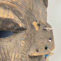 Pakabinama medinė afrikietiška kaukė, inkrustuota kriauklėmis 14,5x19x36 cm