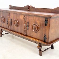Ąžuolinė trijų durų komoda su drožinėtais karių biustais ir metalo apdailomis 57x225x112 cm